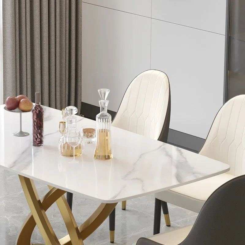 Tavolo da pranzo moderno con piano rettangolare in pietra sinterizzata e base dorata